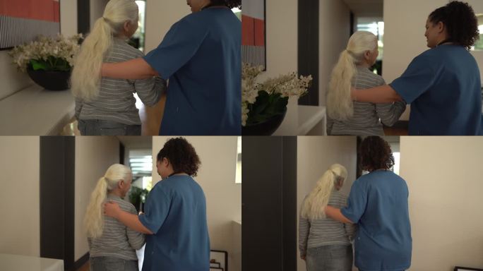 护士帮助老年病人在家散步