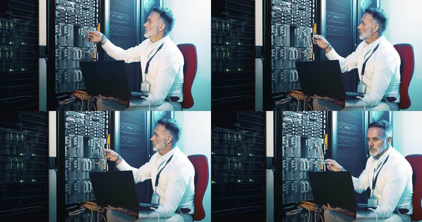 一个成年男子在服务器室工作时使用笔记本电脑的4k视频片段