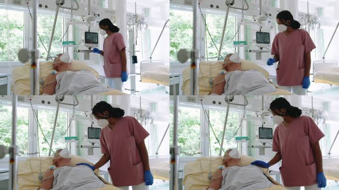 护士正在看重症监护室老年患者的生命体征监护仪