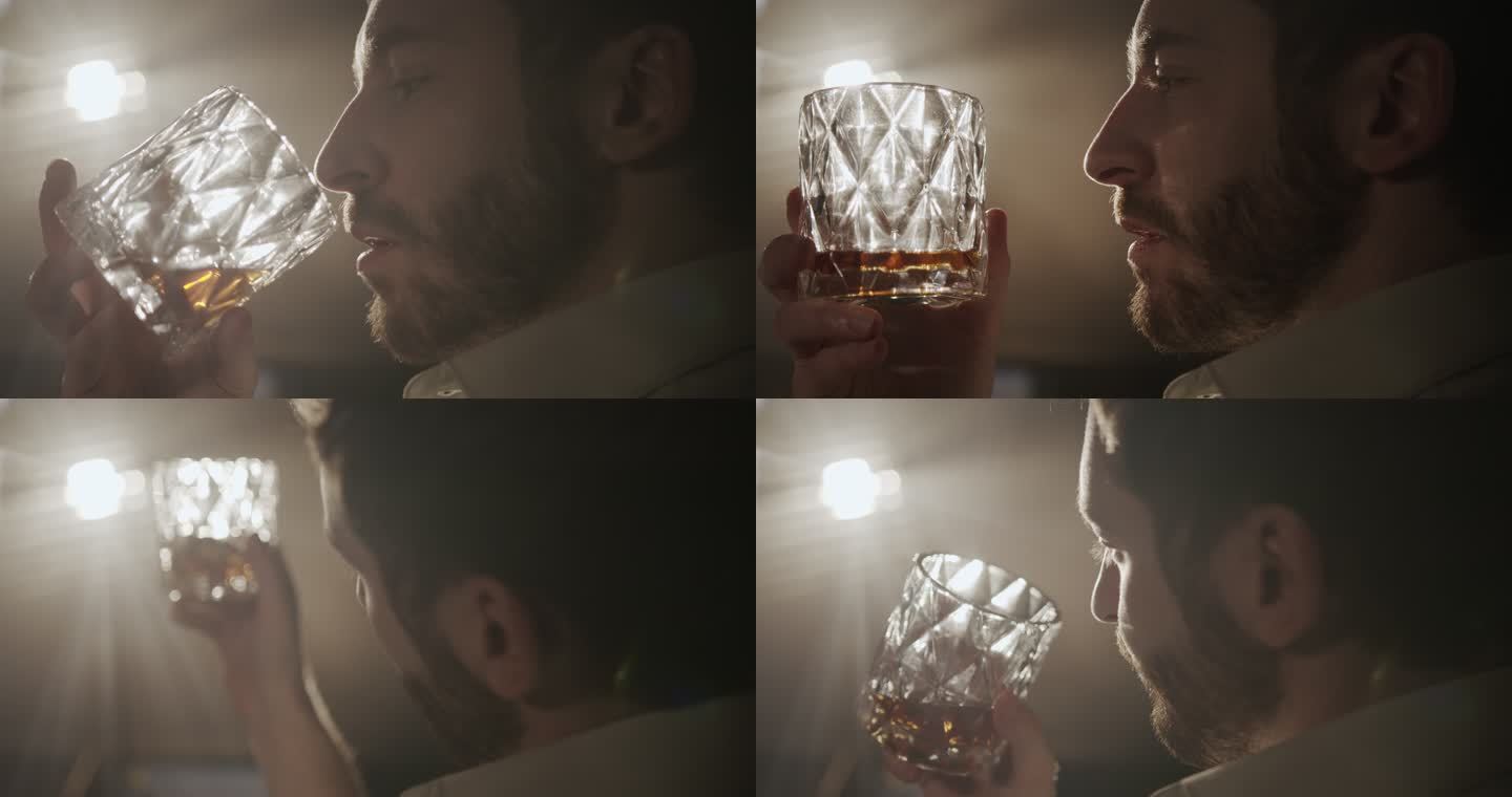 一段后台视频，在聚光灯的明亮灯光下，从一名男子的肩膀上看到他喝着杯里的威士忌