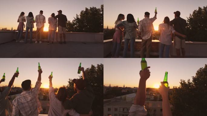 夕阳下，朋友们在屋顶上举着啤酒手的背影。