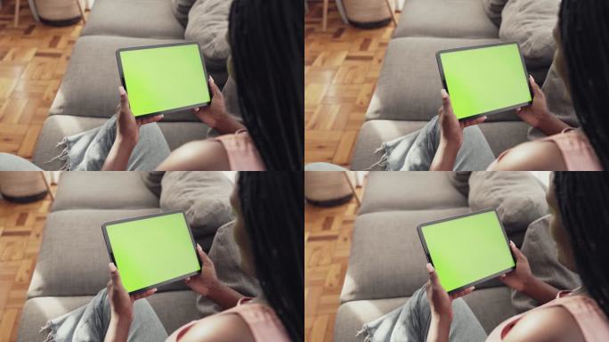一个无法辨认的妇女在家中使用平板电脑的4k视频片段