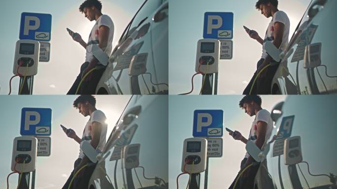 斯洛·莫：一个年轻人在停车场给他的车充电时使用他的智能手机