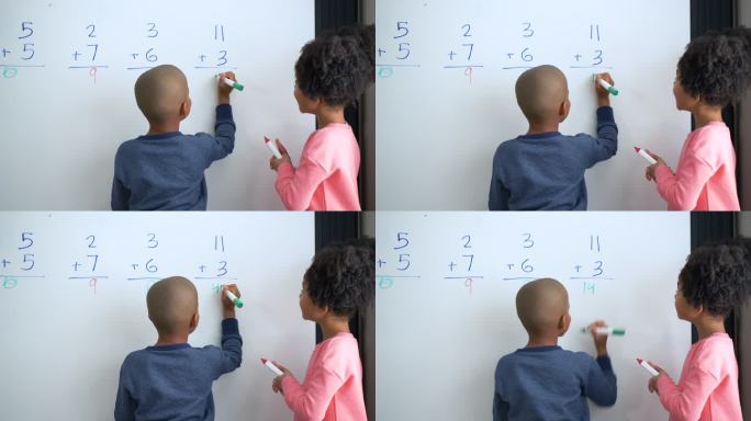 两个非洲裔美国儿童在白板上做数学