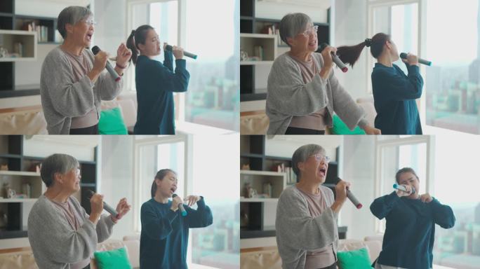 周末休闲活动期间，一名亚裔华裔高级女性在客厅与女儿唱歌、卡拉OK跳舞