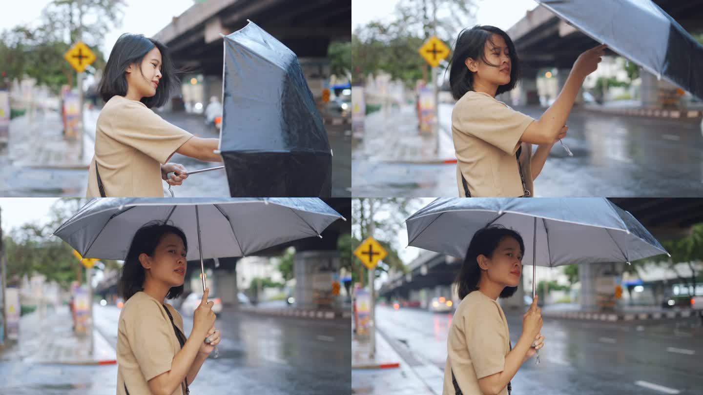 亚洲女人打开伞大雨来临一个人无助美女撑伞