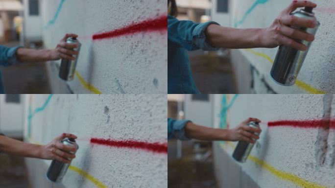 涂鸦艺术家在墙上喷涂的手
