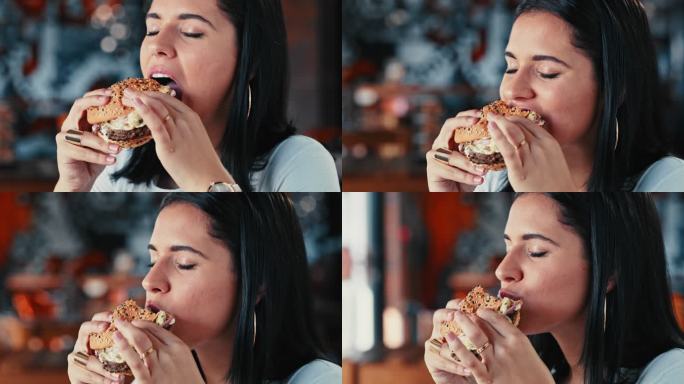 一名年轻女子在餐厅享用汉堡的4k视频片段