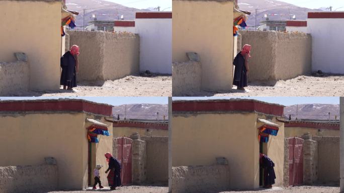 藏族老人站在门口    老人和小孩