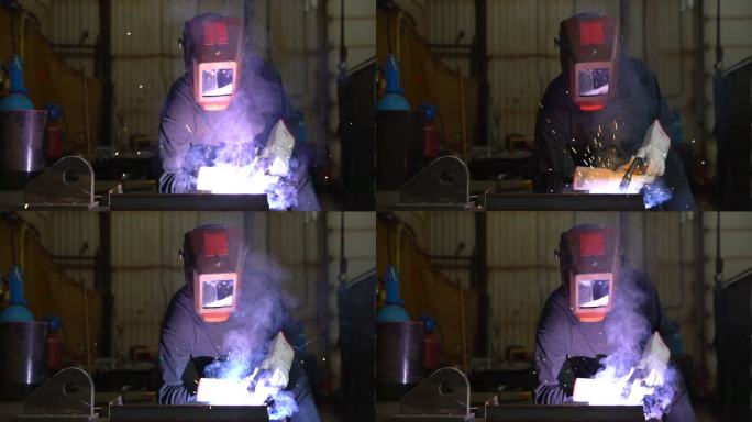 焊工的视频肖像。火星四射钢铁行业加班电焊