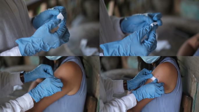 在接种新冠肺炎疫苗后，一名身份不明的医生在越南患者手臂上贴上了胶粘绷带
