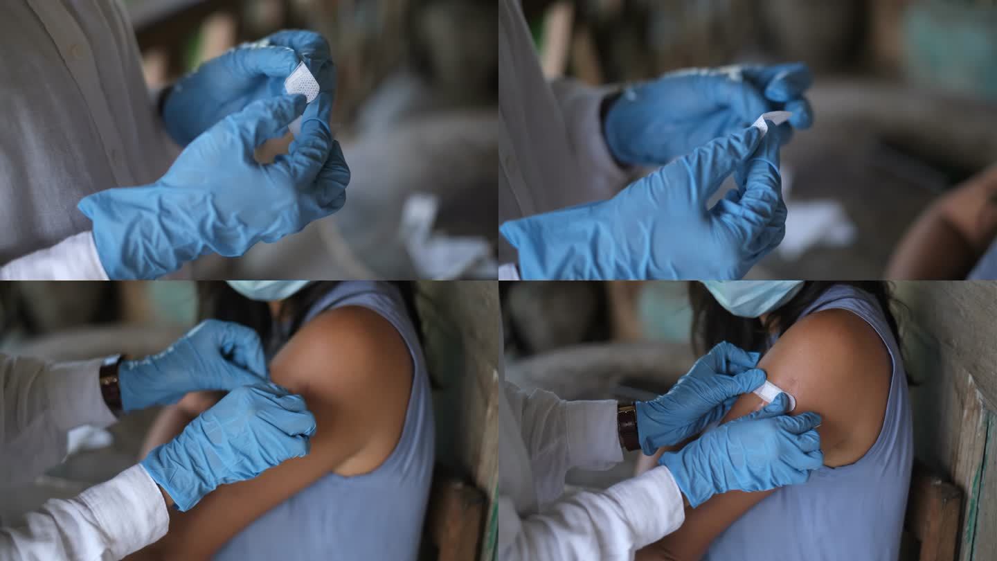在接种新冠肺炎疫苗后，一名身份不明的医生在越南患者手臂上贴上了胶粘绷带