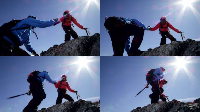 登山者在山上的岩石上互相帮助