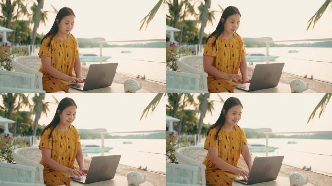 在海滩旅行时使用笔记本电脑的自由职业者。