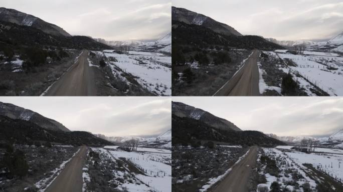 无人机沿着四轮驱动的土路穿越科罗拉多州的雪山