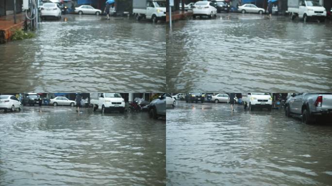 多莉在曼谷的山洪中拍摄了洪水淹没的房屋、汽车和街道，慢镜头