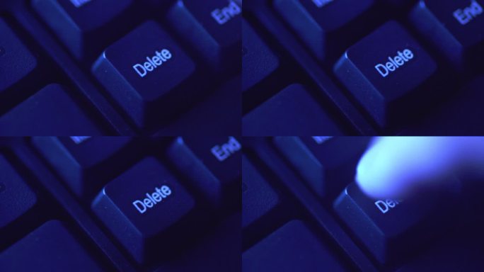 特写手指：手指按下计算机键盘上的“删除”按钮