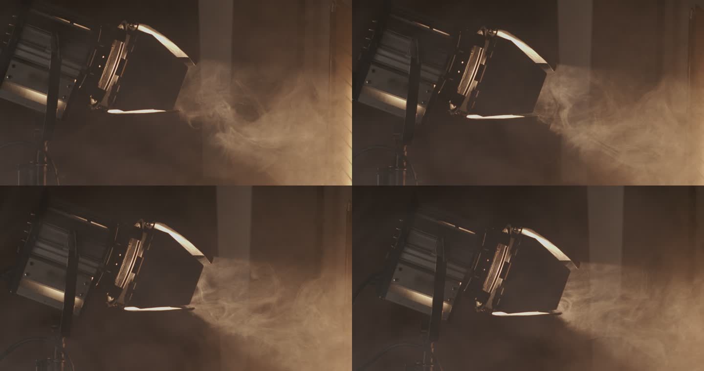 在工作室拍摄期间，专业聚光灯照亮烟雾弥漫的房间的特写镜头