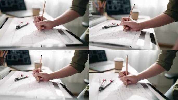 建筑师在办公室办公桌上绘制蓝图，工程师在草拟建筑项目概念