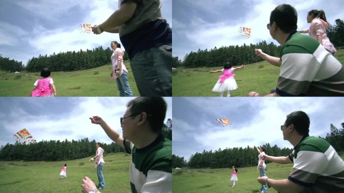 夫妻二人带小孩野外玩耍草坪放风筝近景02