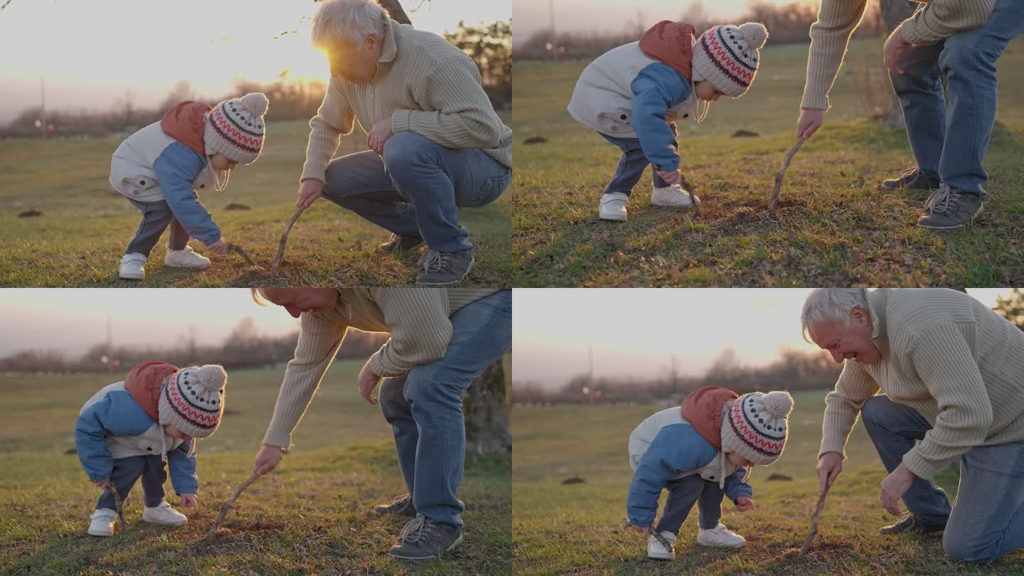 爷爷和孙子在草地上玩棍子