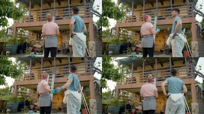 斯洛-莫夫妇在阳台上刷了木栅栏后，向对方击掌