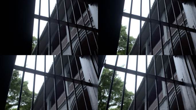 重庆市沙坪坝白公馆透过铁窗拍室外建筑