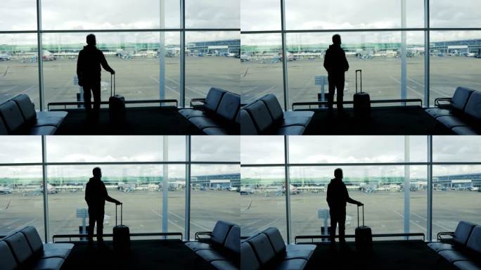 一名中年男子在机场向窗口挥手告别，这是一个旅游概念，