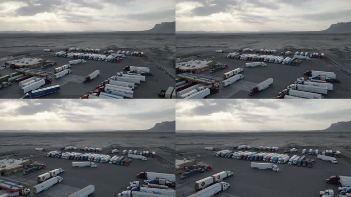 黄昏时分，在犹他州东部沙漠的一个大卡车站，一架无人机将半卡车停在那里