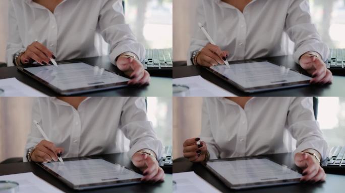 女商人使用数字平板电脑在办公室签署法律文件