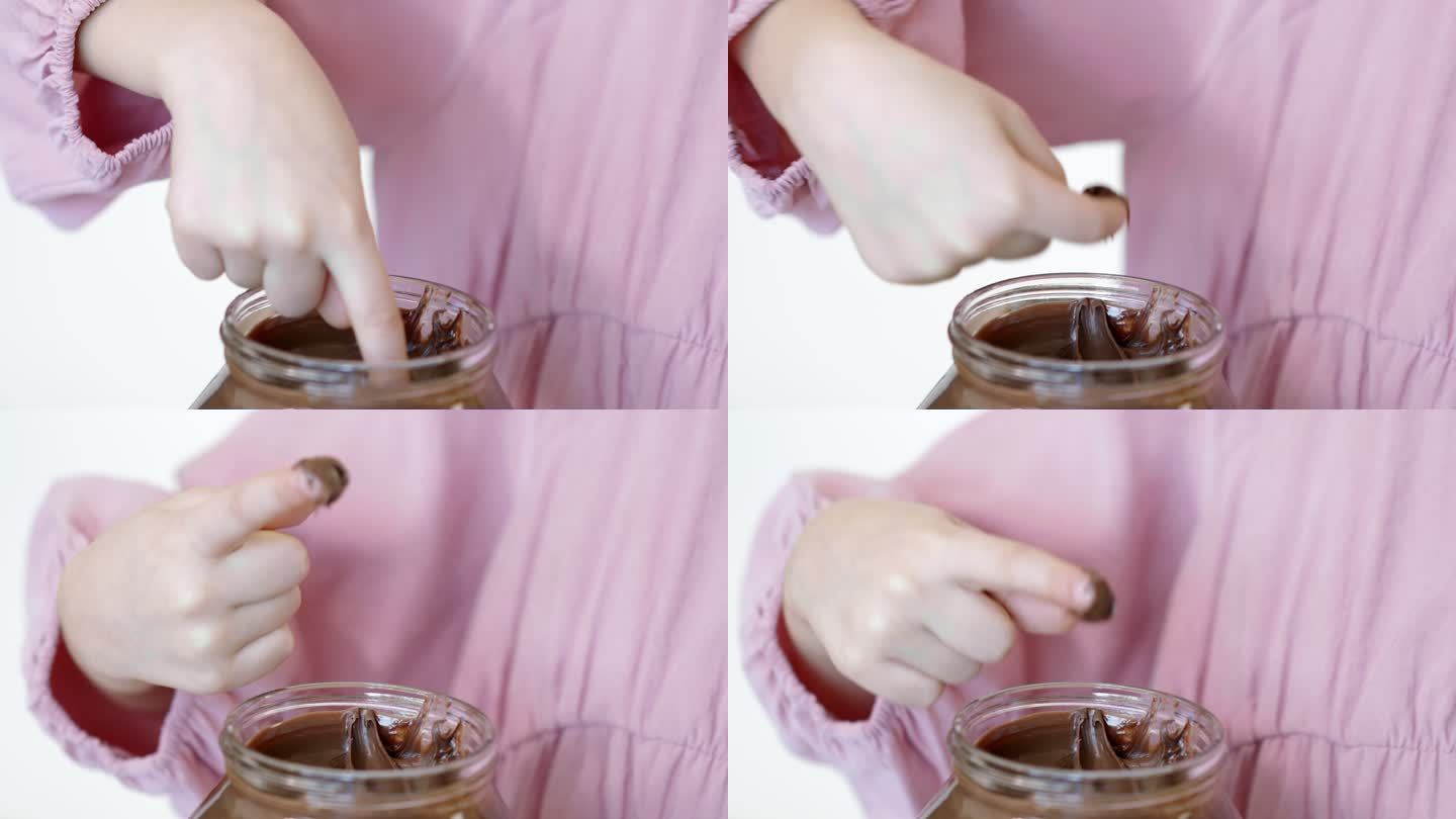 孩子用手指蘸巧克力奶油，用手指吃巧克力