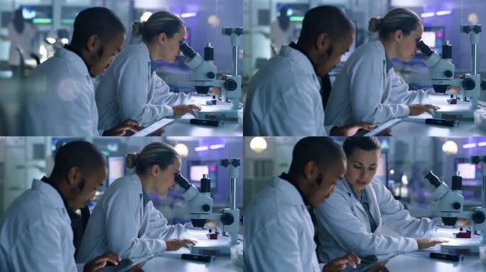 两名科学家在实验室使用显微镜和数字平板电脑的4k视频片段