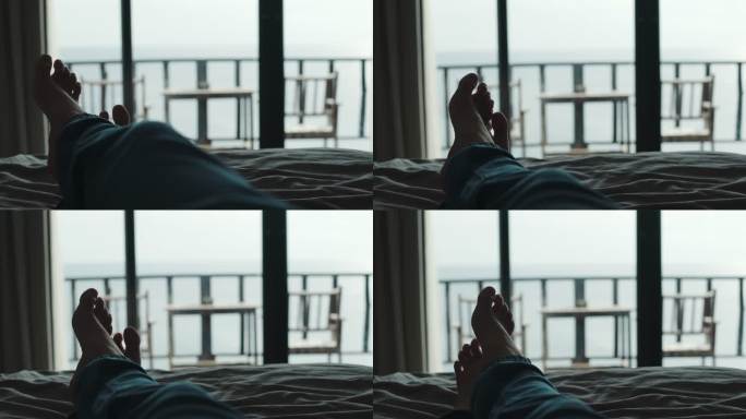 在度假期间，放松的人们躺在床上的毯子上，交叉双腿，在酒店度假区看风景