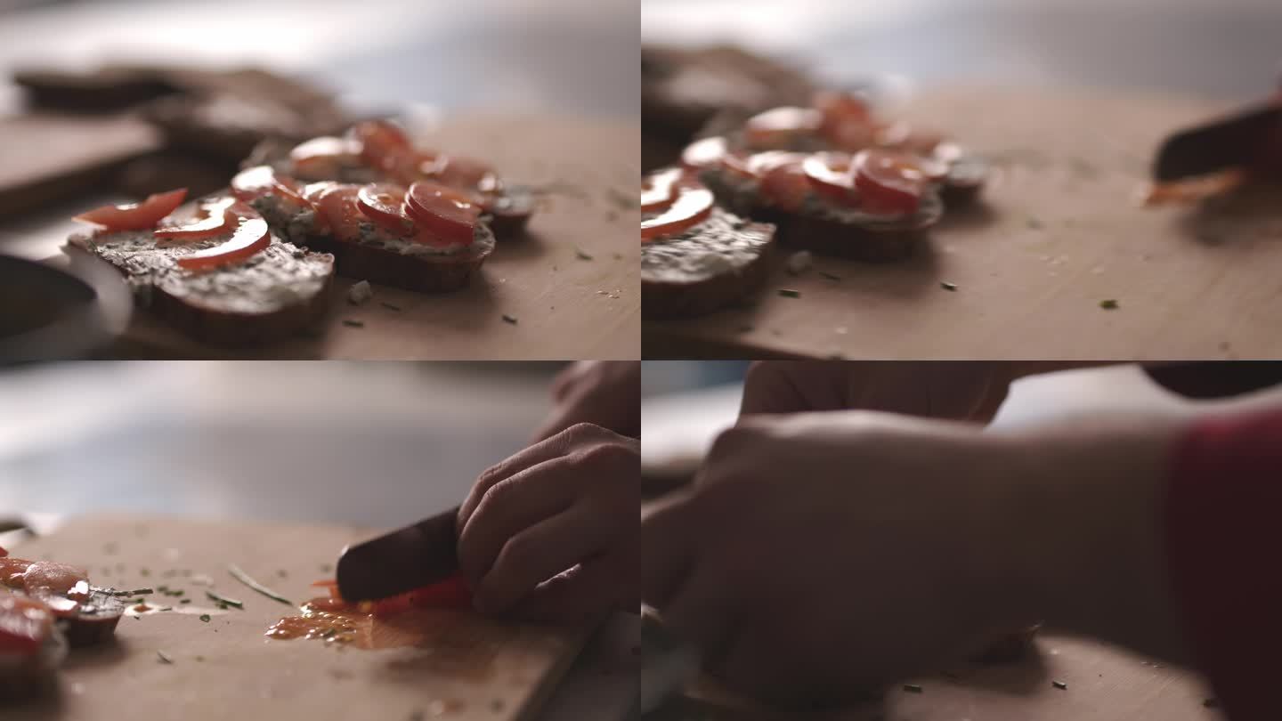 厨师在三明治上安排和切割番茄片的特写镜头