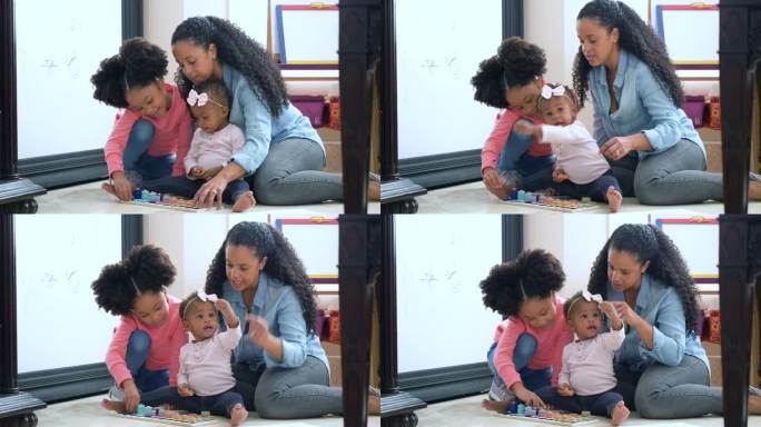 非洲裔美国母亲和女儿玩婴儿