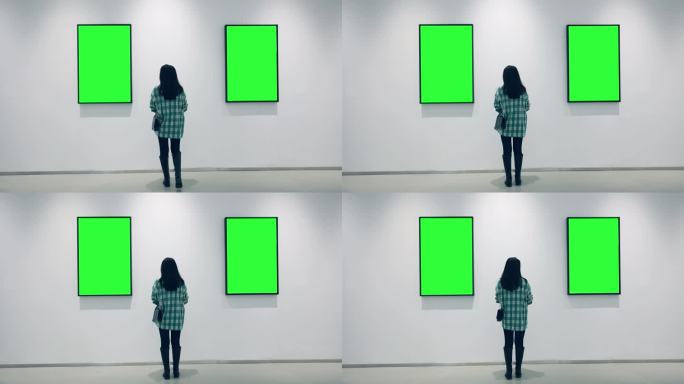 一位年轻女子在美术馆里看着绿色的画框