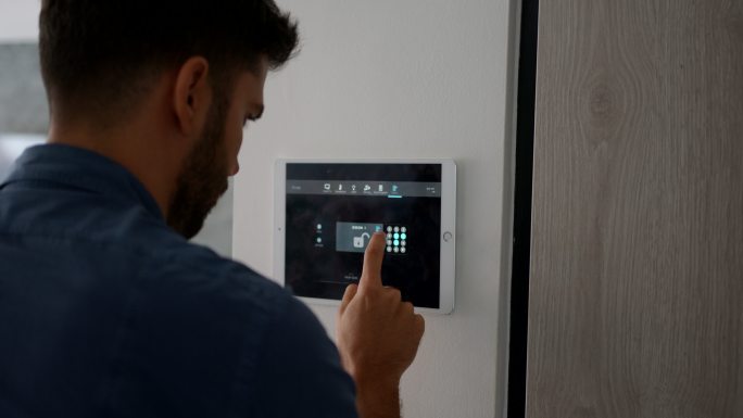 一名拉丁美洲男子离开他的自动化家庭，激活数字平板电脑上的锁，介绍他的pin码