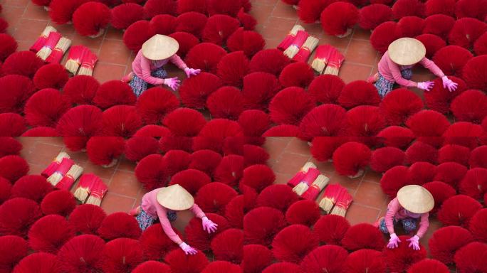 越南妇女在河内省越南北部的老传统房屋的地板上布置香，传统艺术和文化