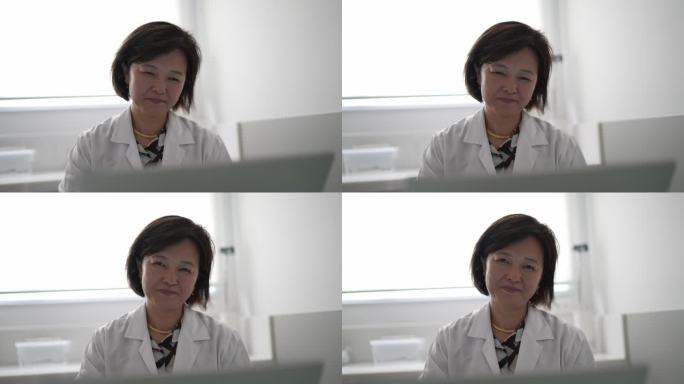 一位医生在医疗诊所的笔记本电脑上工作的肖像