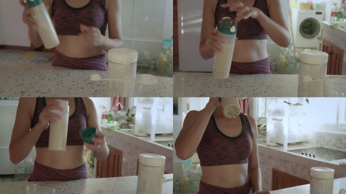 一位穿着运动服的亚洲年轻女子在家里的厨房里用蛋白粉制作奶昔，喝蛋白奶昔。