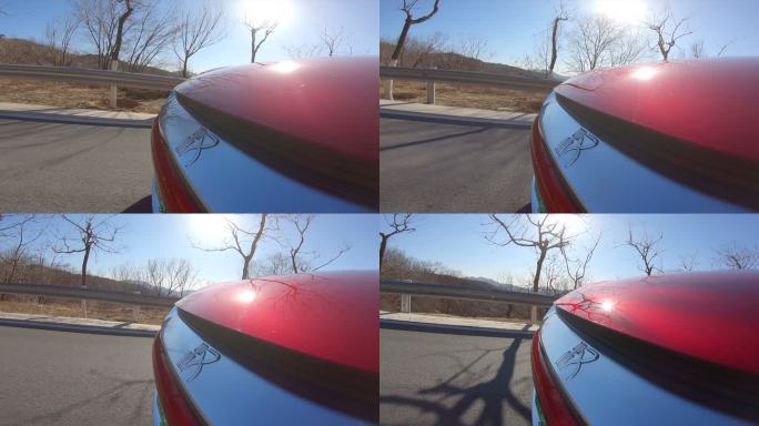 红色电动车山路行驶 车头特写 树林背景