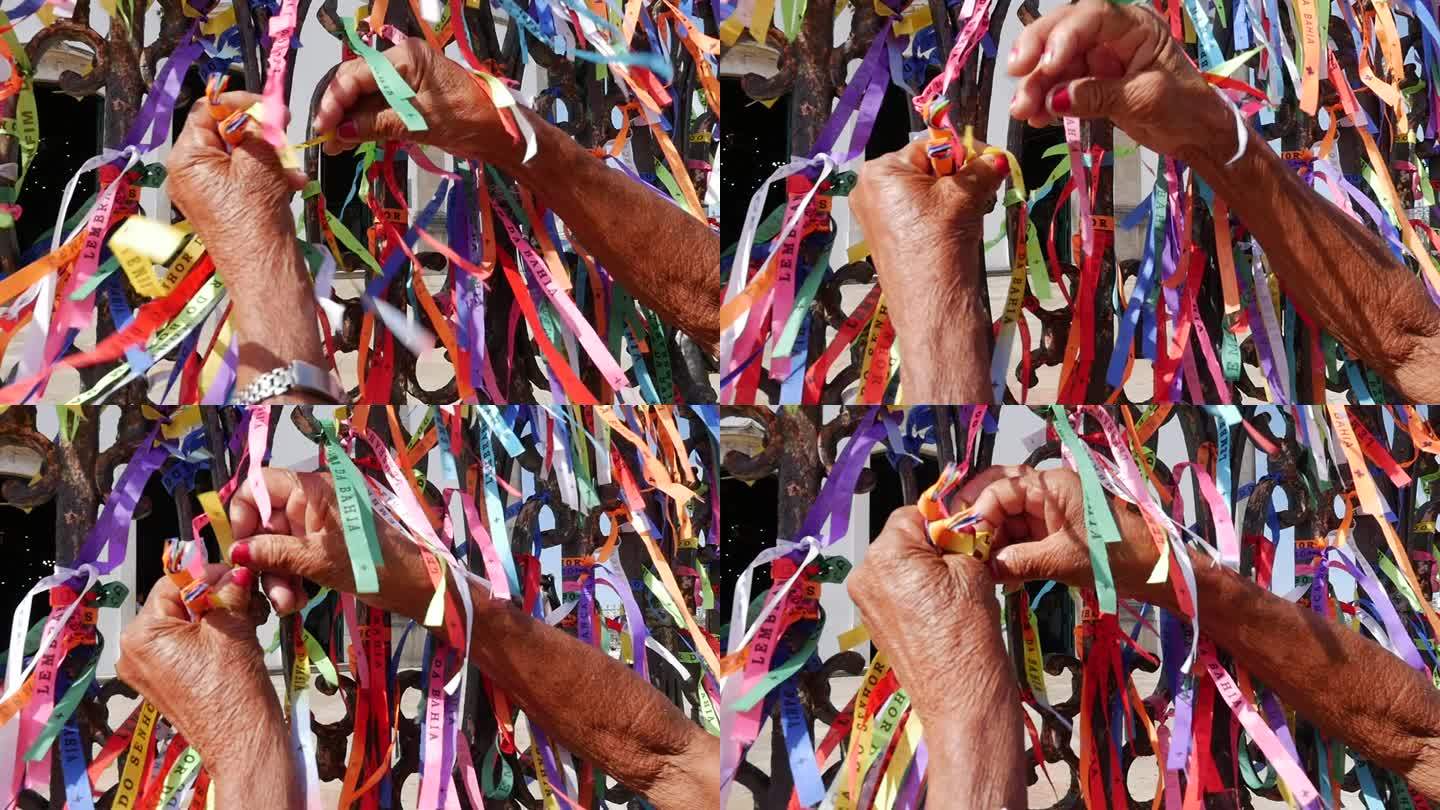 巴伊亚州萨尔瓦多的邦菲姆主教堂上绑着丝带的女性双手
