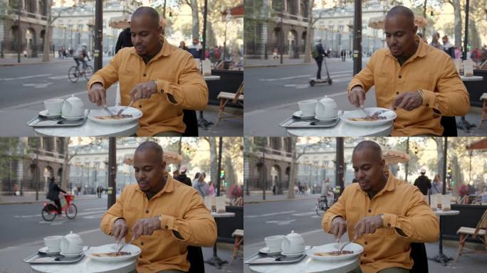 黑人在路边咖啡馆吃法国早餐