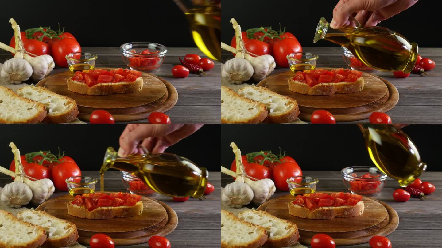 手拿一瓶橄榄油，将特级初榨橄榄油倒入带有西红柿的布氏干酪上，餐桌上摆放着黑色背景的意大利地中海菜肴的