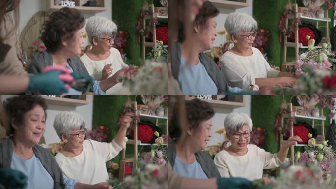 亚裔中国老年女性在花店向女花商学习插花