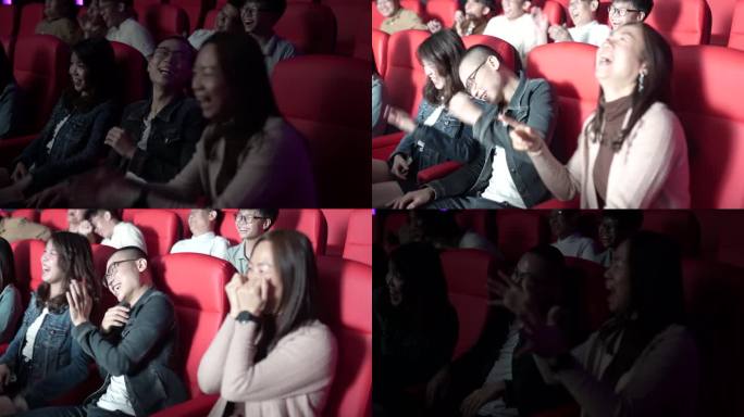 一位亚裔中国母亲和她的孩子在电影院看喜剧电影，在电影院里笑