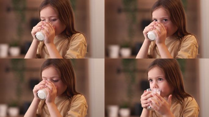 一个快乐的女孩正在家里喝新鲜的酸奶。