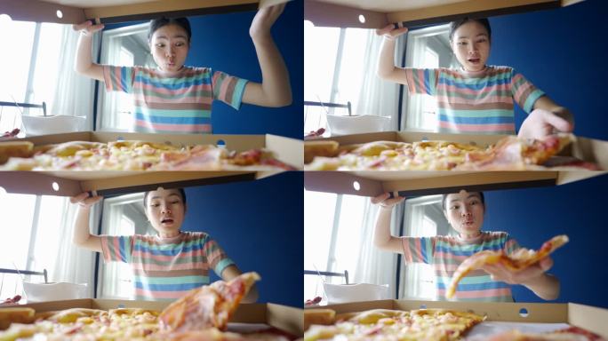 在亚洲，一个十几岁的女孩正在家里吃披萨。