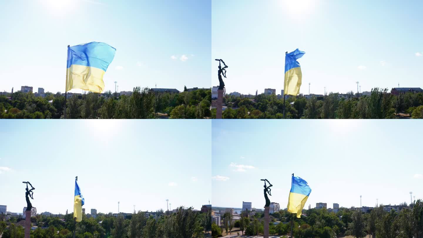 无人机拍摄的乌克兰国旗在微风中飘扬，背景是一座森林城市