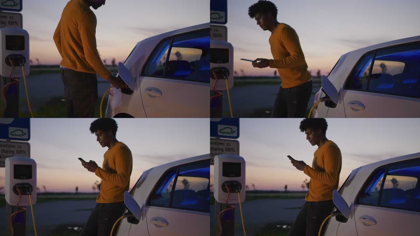 黄昏时分，斯洛·莫曼在停车场为他的电动汽车充电